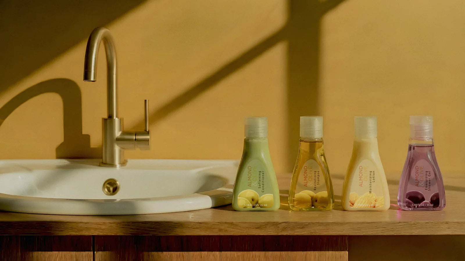 Almond and Olive amenities beside a sunlit washbasin